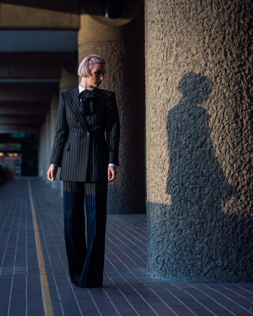 Person posing with her shadow in the back